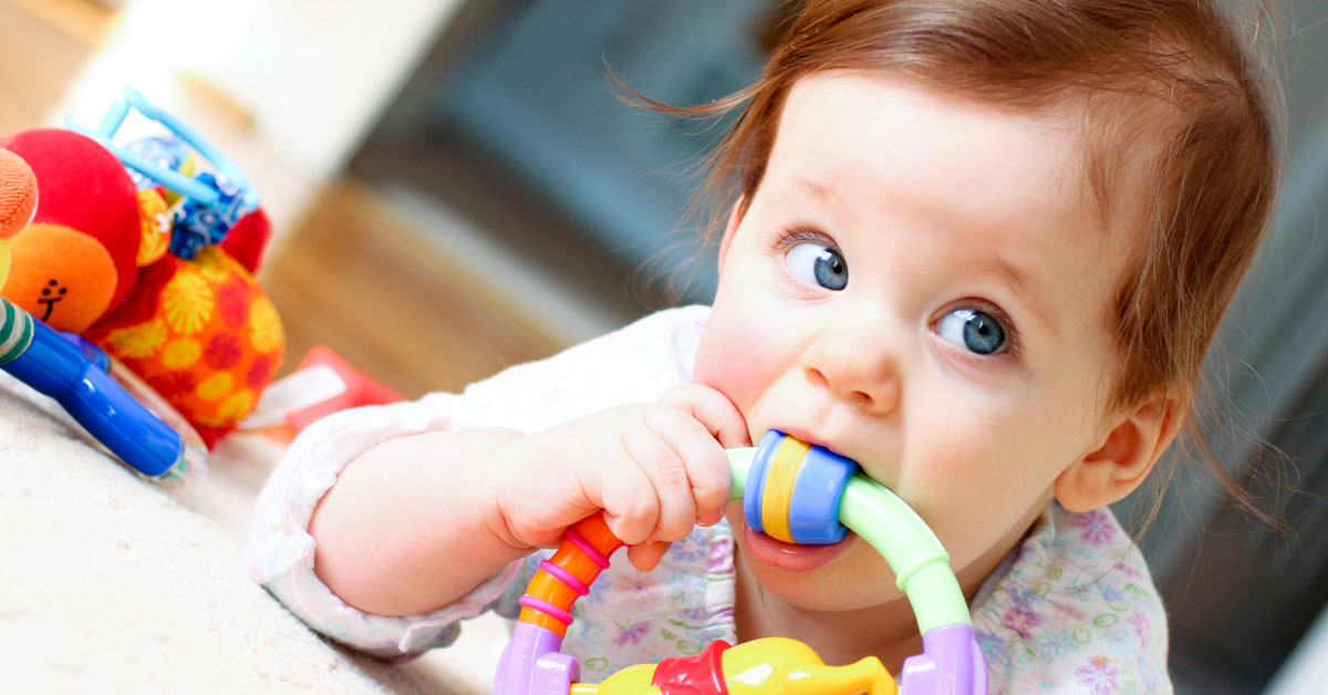 Baby chewing on teething toy